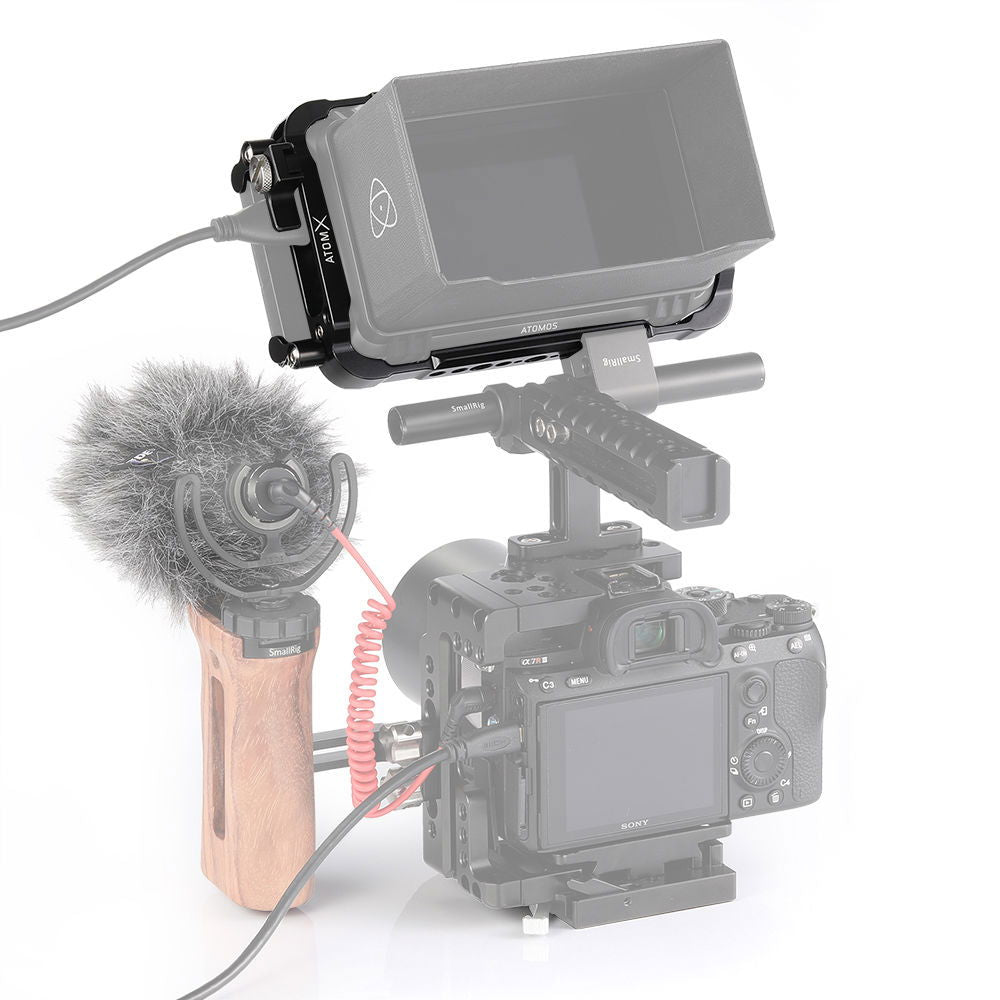 Atomos Ninja V 5in cage mounted on camera with screen cover and microphone