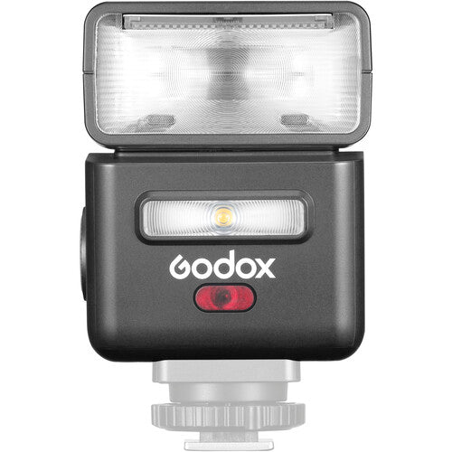 Mini TTL speedlite with open flash head and glowing LED window, dark body