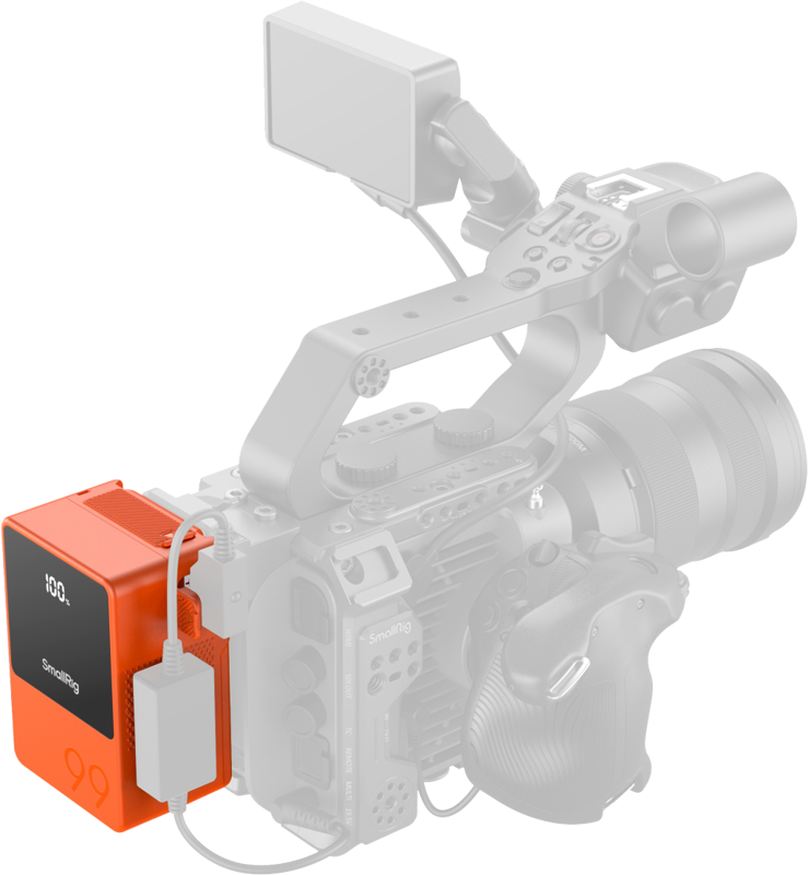 Orange V-mount battery attached to camera rig with cable connections and LCD display