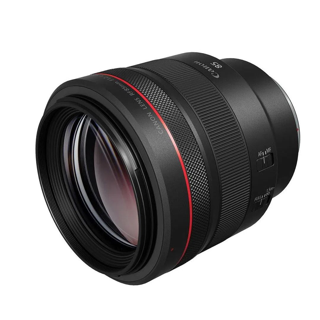 Side view of black RF85mm f/1.2 lens, glass front and AF/IS labels visible