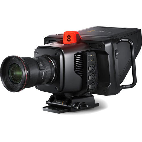 Camera side view with attached lens, matte box area, and red top marker