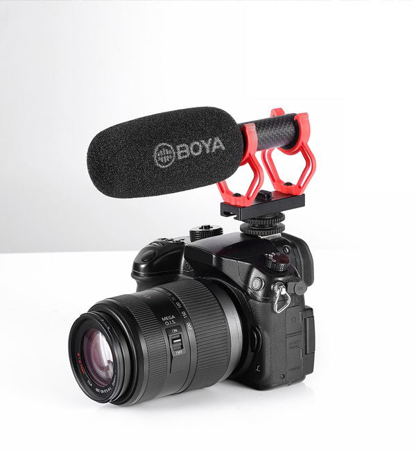 Shotgun mic on camera with red shock mount and round foam windscreen