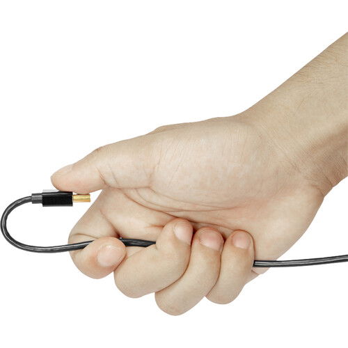Hand holding ultra-thin 35 cm HDMI cable with black connectors