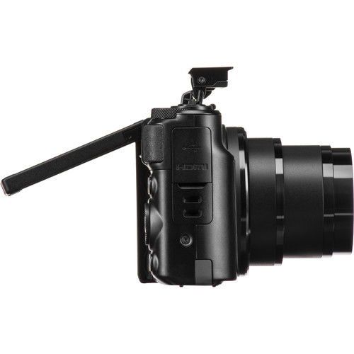 Side view of Canon PowerShot SX740 HS with extended lens barrel and grip controls