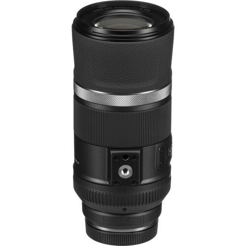 Black telephoto lens side view with textured body and visible control knobs
