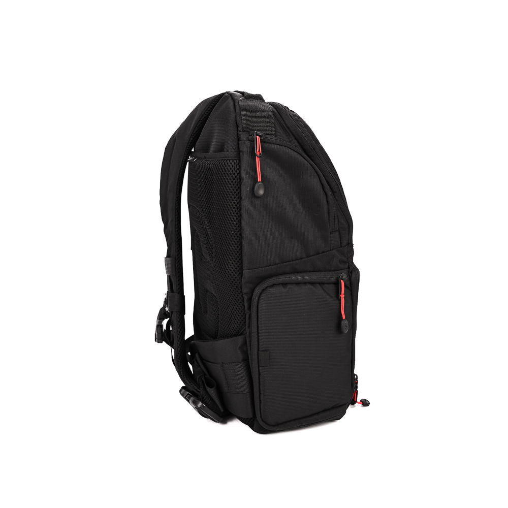 Andex 1 sling camera backpack, black side view with zip pocket and top carry handle
