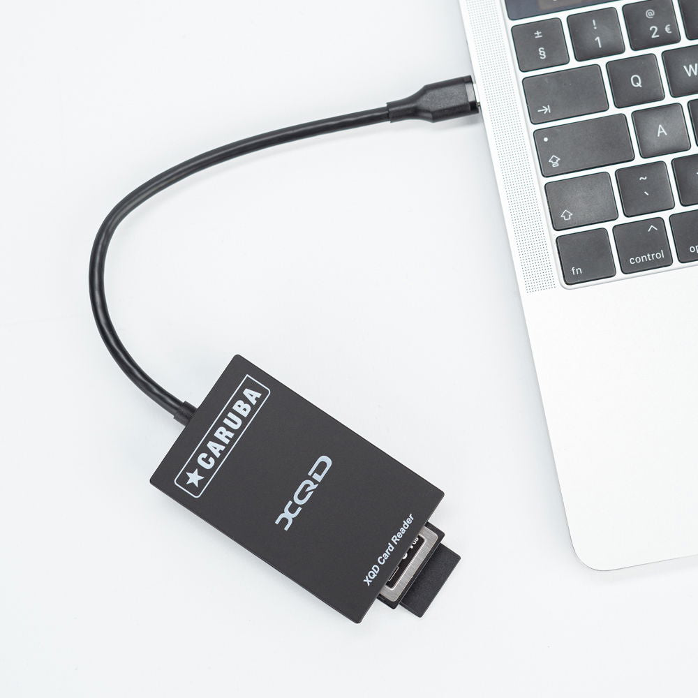 XQD and SD USB-C card reader connected to laptop, compact black unit