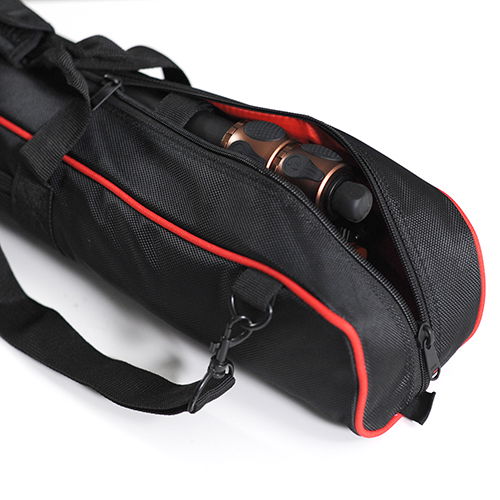 Side pocket on tripod bag cover with zipper, black case with red piping, small accessories visible