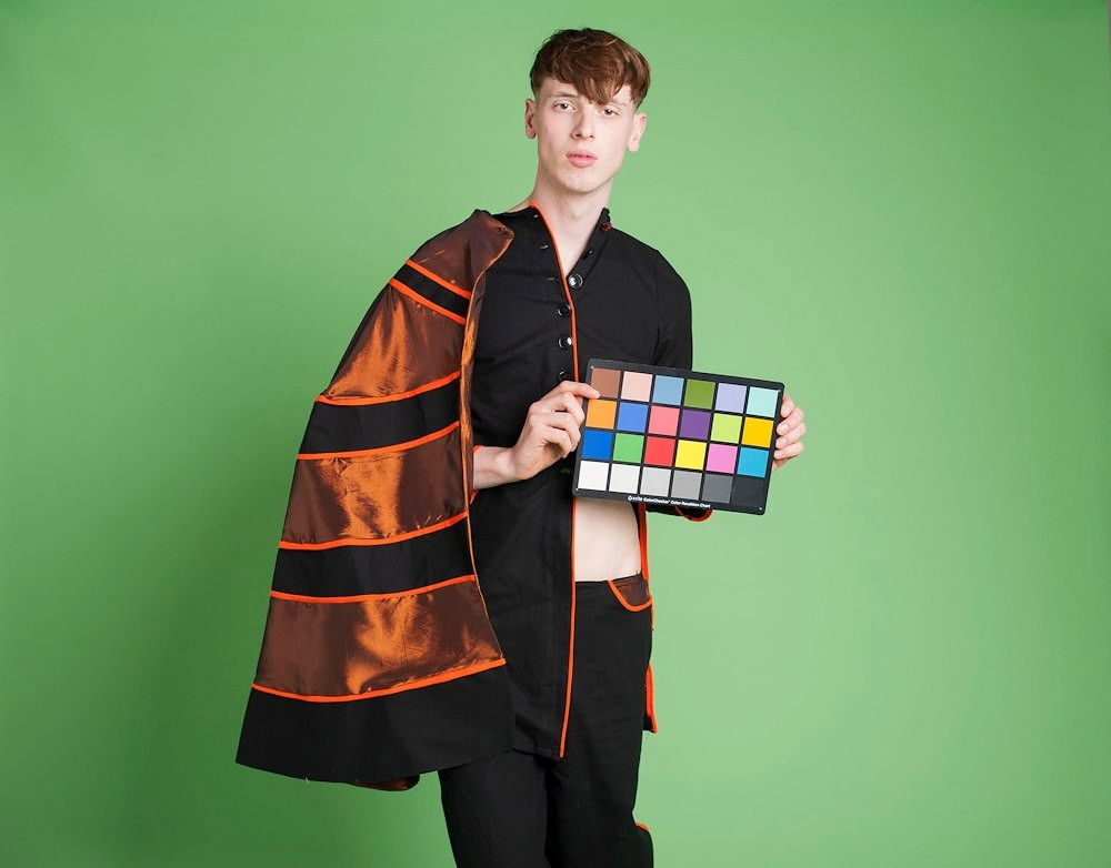 Green photo studio backdrop sheet, seamless background behind model