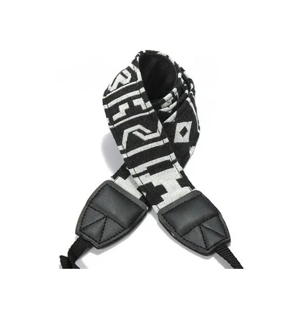 Camera strap detail with black/white patterned fabric and two black leather end pads