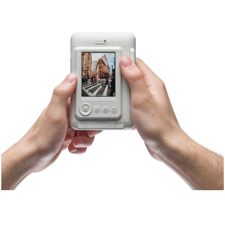 Misty white Instax mini LiPlay instant camera held in hands, LCD shows photo