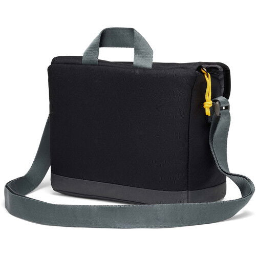 Black camera bag side view with wide shoulder strap and yellow zipper pull