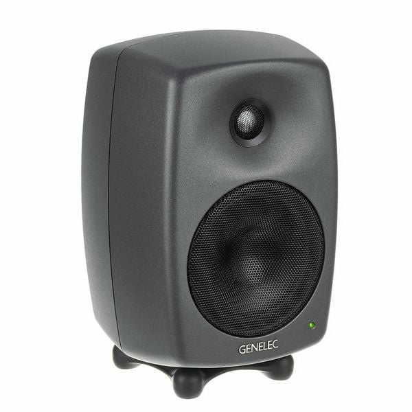Dark gray active studio monitor speaker, angled side view showing front drivers