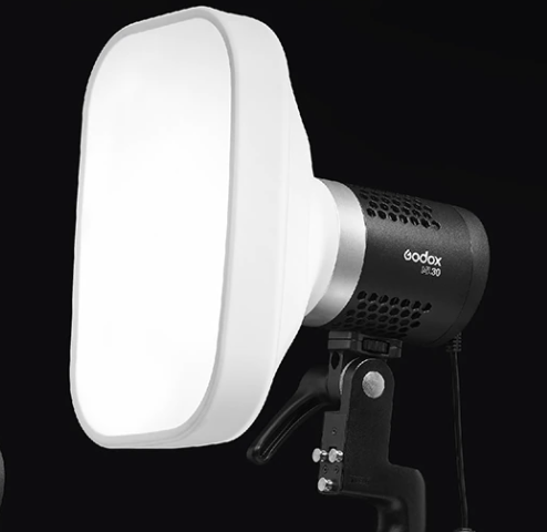 White silicone softbox diffuser attached to the flash head, close-up