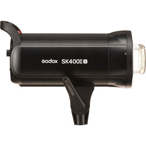 Black studio flash unit side view with front mounting and exposed lamp bulb