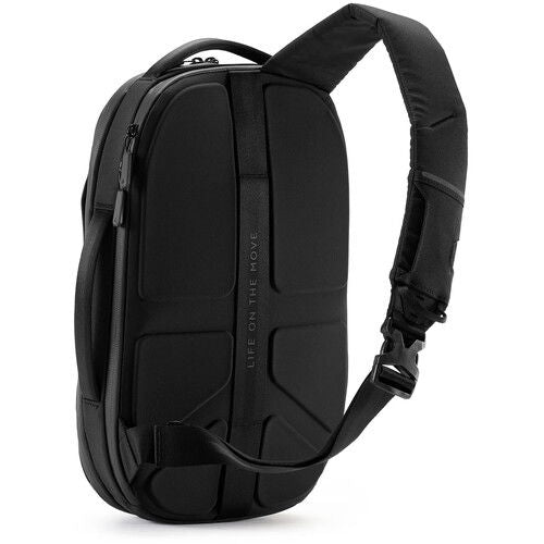 Black sling backpack side/back view with padded back panel and adjustable strap