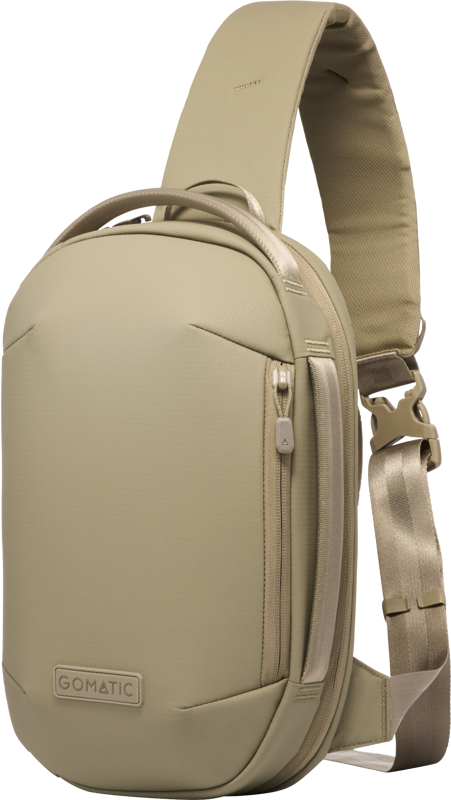 Sand beige sling bag side view with adjustable strap and zip pull tab