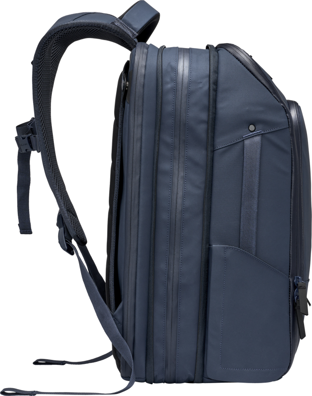 Navy travel backpack angled side view with multiple vertical side seams and strap