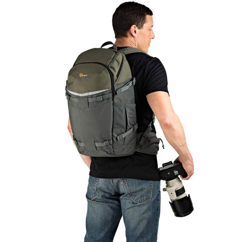 Olive and gray photo backpack, side view with shoulder straps and camera-ready access