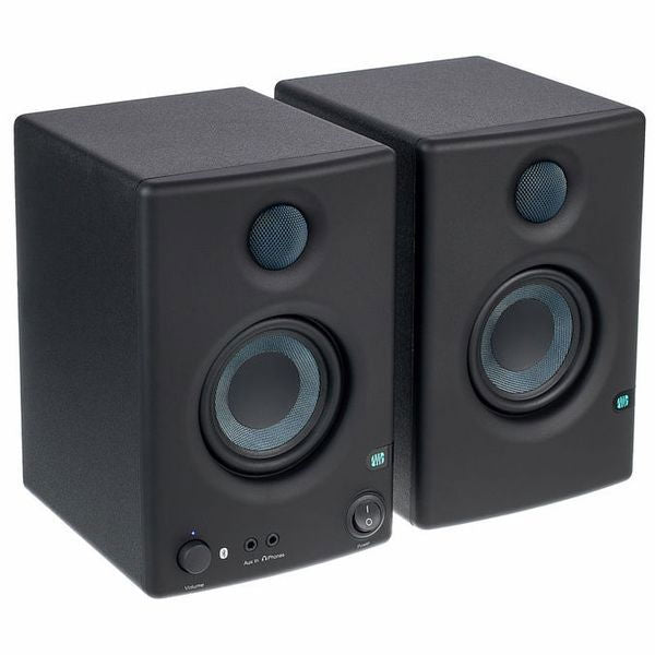 Front view of two dark studio monitors showing tweeters and woofers