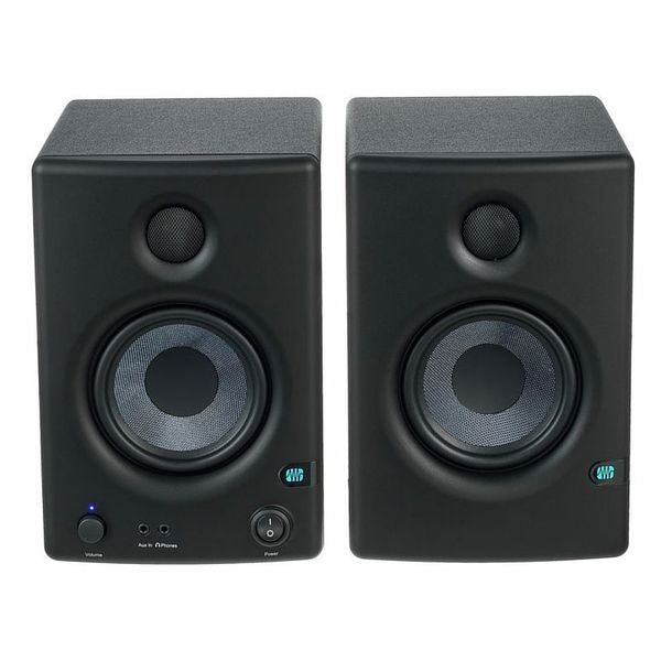 Front view of two black studio monitor speakers with circular drivers and controls