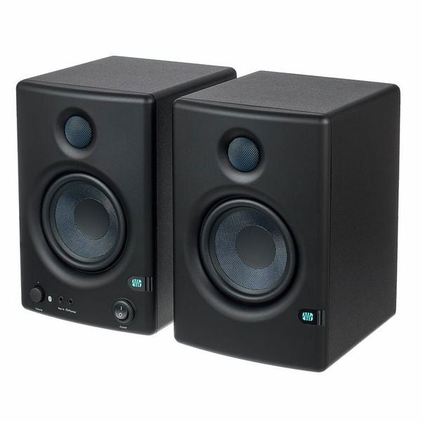 Black studio monitor speakers with front woofers and tweeters, side-by-side view