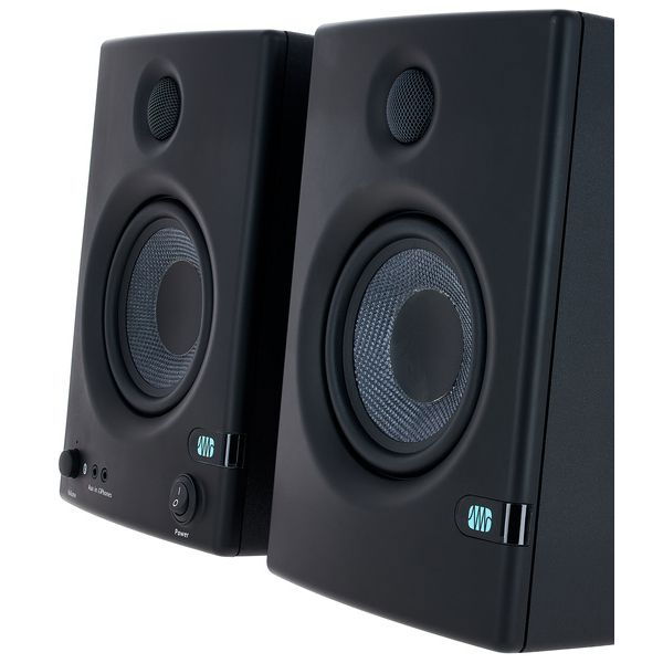 Close-up angled front of black studio monitor speakers, tweeter and woofer