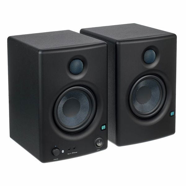Studio monitor speakers in angled view, front tweeter and woofer drivers visible