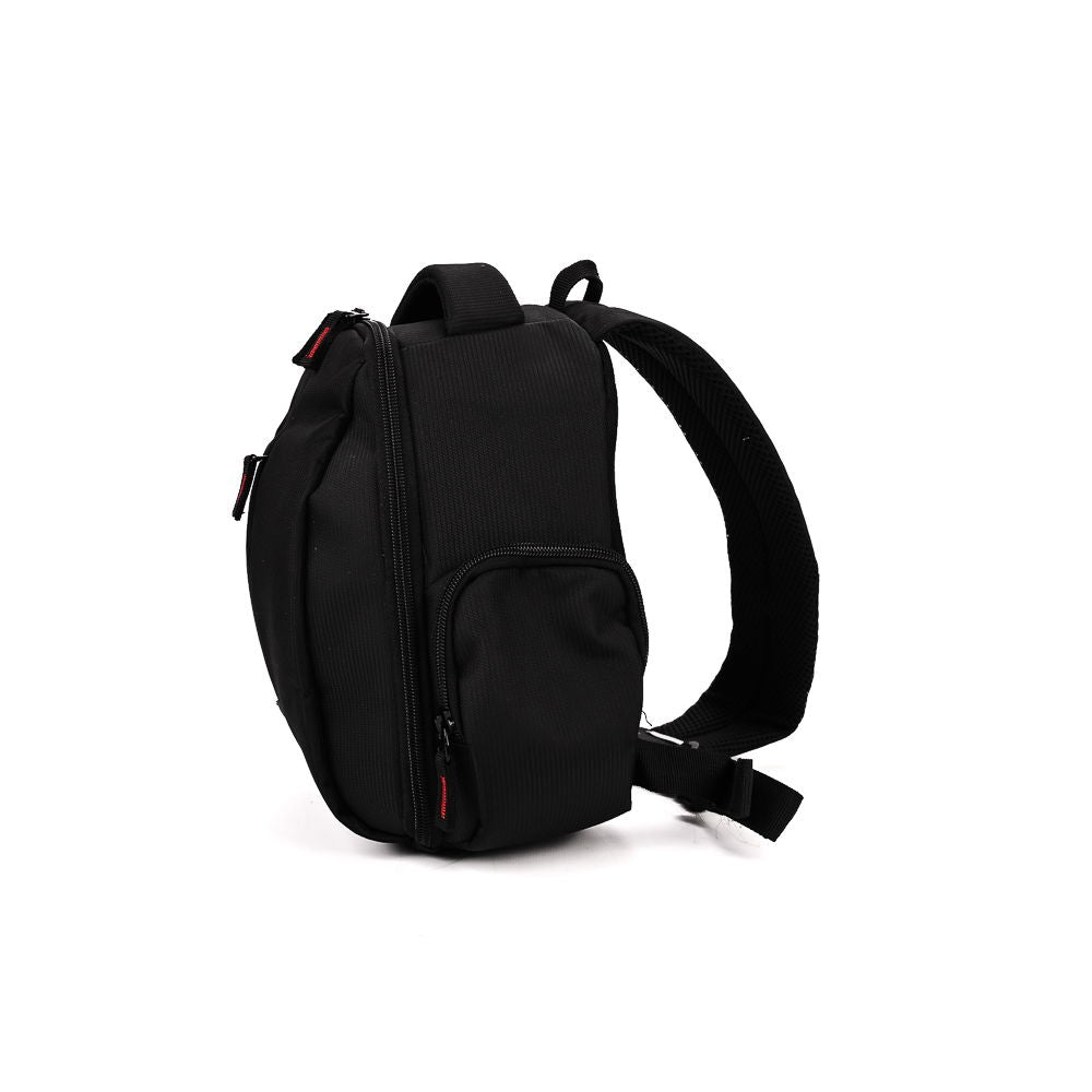 Black compact camera backpack with side carry handle, shoulder strap, and front zip pocket.