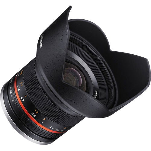 Black lens from side angle, hood open, visible focus and aperture rings, lens glass