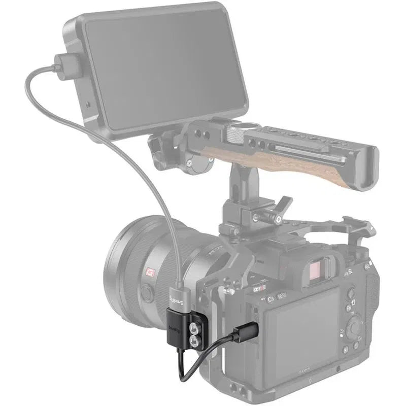 HDMI adapter mounted to camera rail, black block with two mounting screws