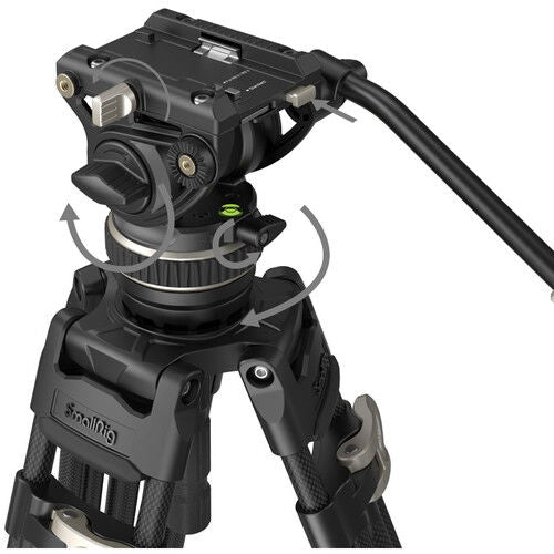 Close-up of fluid video head with adjustment knobs on black tripod