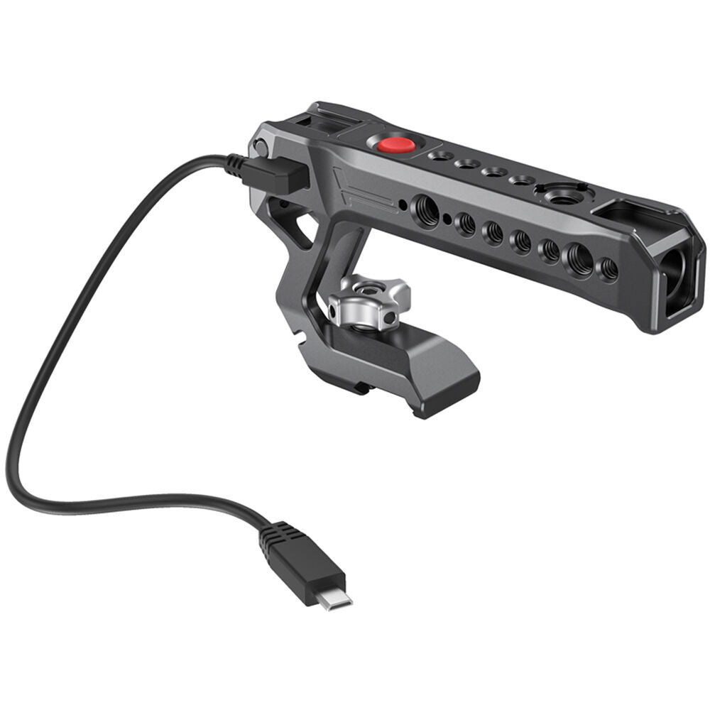 NATO top handle with red button; side ports and cable connector, dark metal body