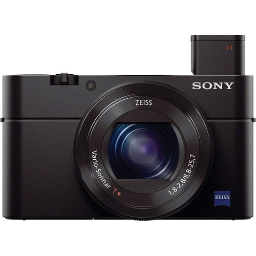 Black compact camera front-right view with raised top flash and centered lens.