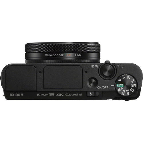 Side view of black compact camera showing zoom lever and mode buttons