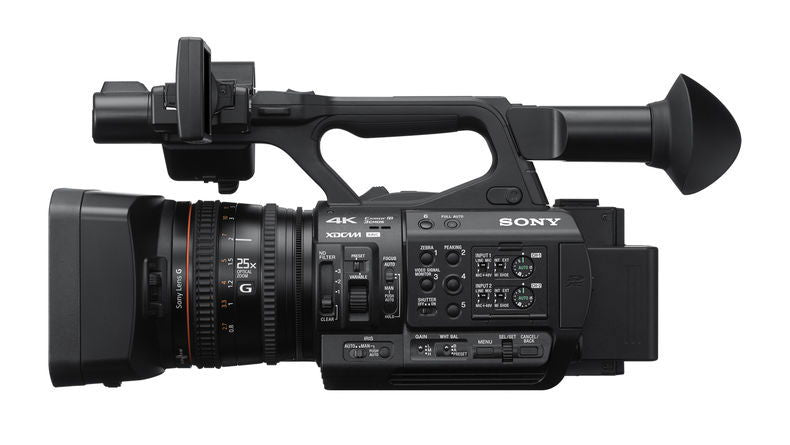 Black 4K professional video camera side profile with lens and top handle