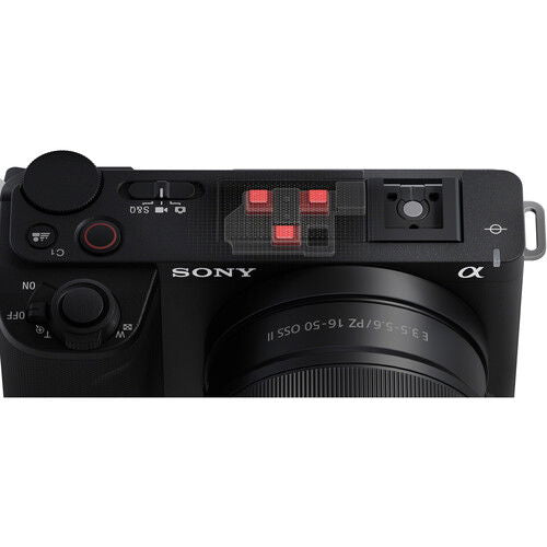 Top view of black mirrorless camera body with controls and lens