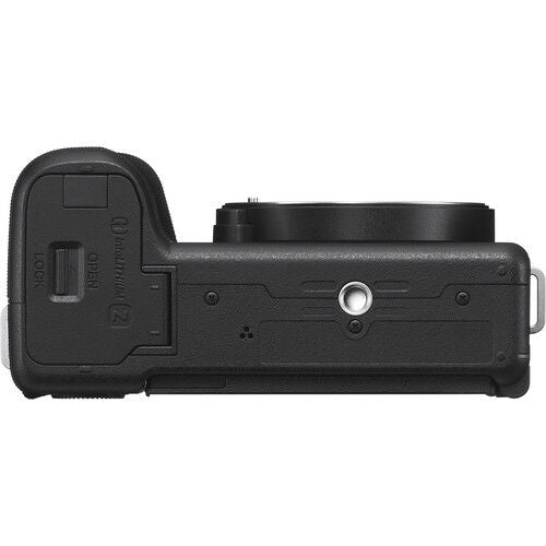 Black mirrorless camera body side showing textured grip and port cover