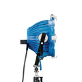 Blue stage light fixture with barn doors and black handle, side view