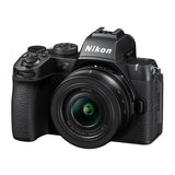 Black mirrorless camera front view with NIKKOR 16-50mm VR lens attached