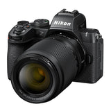 Angled view of black mirrorless camera with textured grip and 16-50mm VR lens