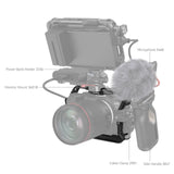 Camera cage with top handle and monitor mount; shows mic, cable clamp, and side grips
