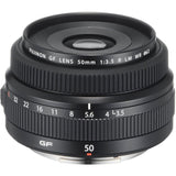 Black 50mm f/3.5 lens with front element opening and engraved focus/aperture rings