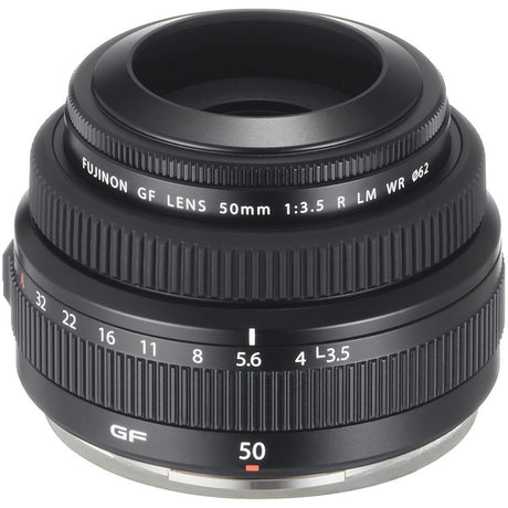 Black 50mm f/3.5 lens side view with ribbed grip, aperture ring numbers, and base rim