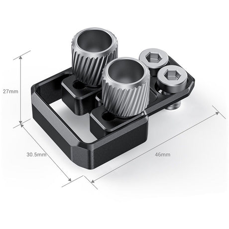 Black dual-port cage accessory with two ribbed connectors and side hex adjustment caps