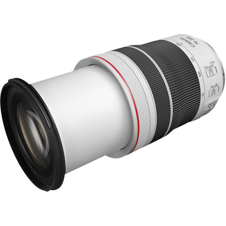 Side view of black and silver 70-200mm F4 telephoto lens, front element facing left