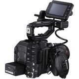 Cinema camera with flip-out monitor, handle grips, and visible connected cables