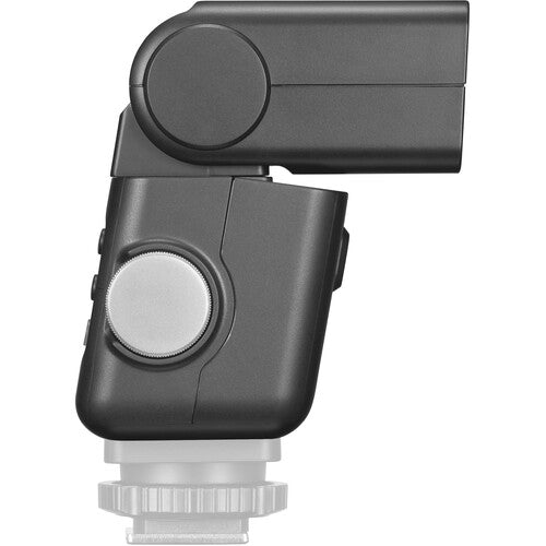 Dark mini TTL speedlite side view with large circular dial and textured housing