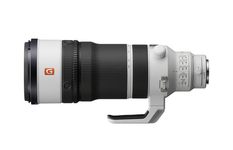 White and black 100-400mm telephoto lens, rear controls and grip handle visible