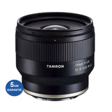 Black Tamron 24mm f/2.8 Di III lens with ribbed grip and front glass
